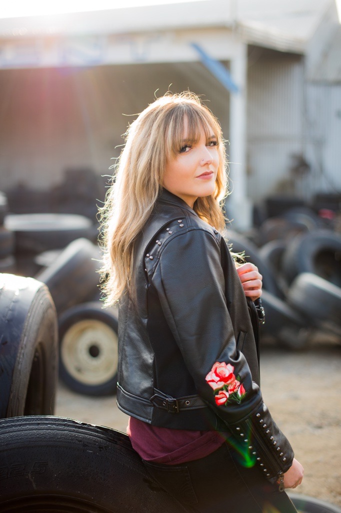 Madison Hudson sitting on a tire